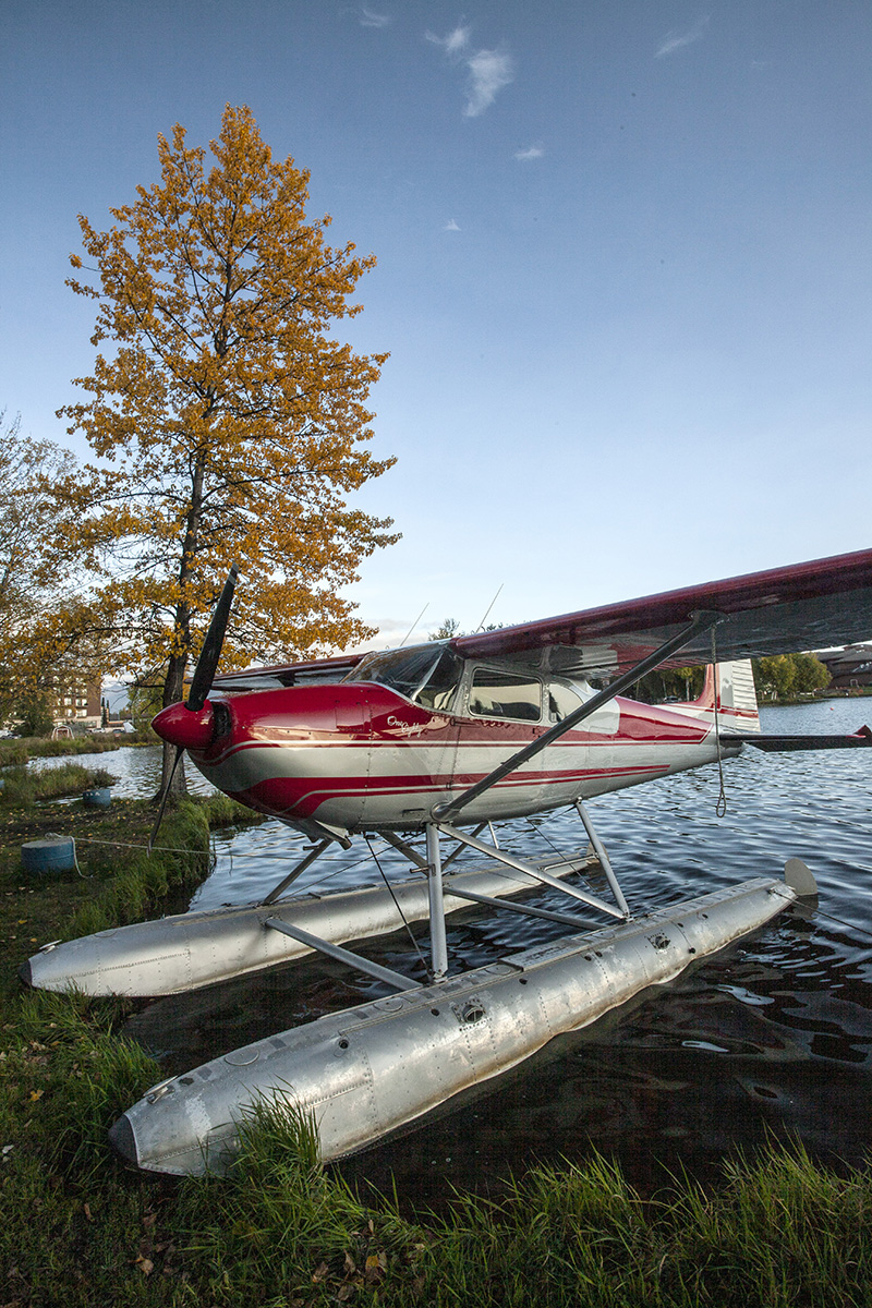 a Cessna floatplane at a shore on pontoons