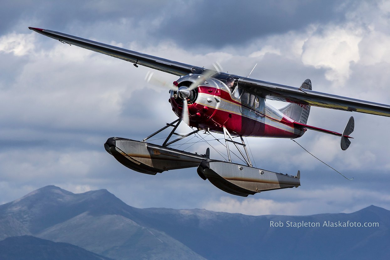 A Cessna on floats air to air type photo